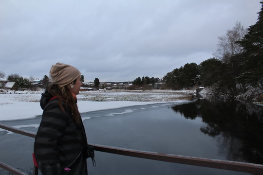 Portrait of a young woman in winter by the river