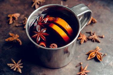 Mulled red wine in metal mug on the gray rustic background. Selective focus. Shallow depth of field.