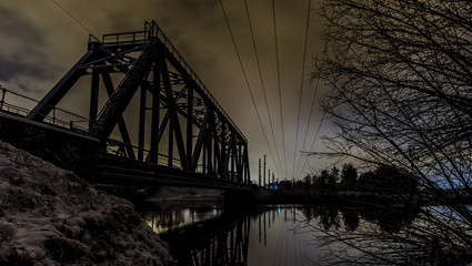 Railroad bridge across the river at night