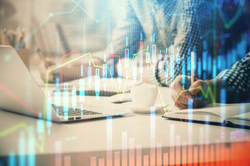 Multi exposure of forex chart with man working on computer on background. Concept of market...