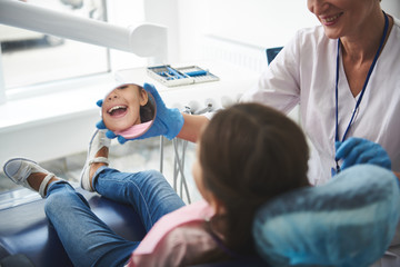 Close up of a mirror in hands of a professional dentist