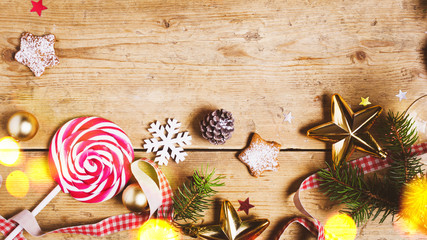 Merry Christmas or New Year holiday concept. Preparation for Christmas gift,  candy lollipop, cookies, ribbons and decorations. Preparation for holidays. Top view with copy space.