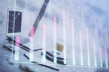 Forex graph hologram on table with computer background. Multi exposure. Concept of financial markets.