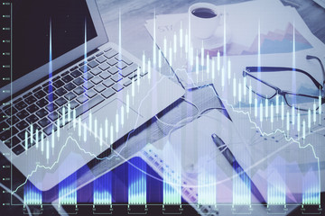 Stock market chart hologram drawn on personal computer background. Double exposure. Concept of investment.