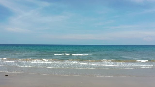 4K Aerial footage view of ocean waves crashing on Beautiful beach by at Sabandar Beach, Tuaran, Sabah, Malaysia