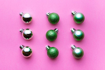 Xmas balls isolated on pink background. Christmas bubble pattern decoration. Flat lay. Winter concept