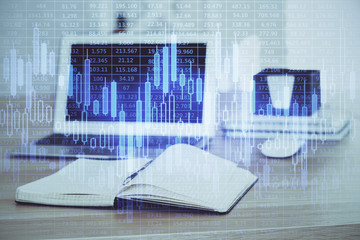 Financial chart drawing and table with computer on background. Double exposure. Concept of international markets.