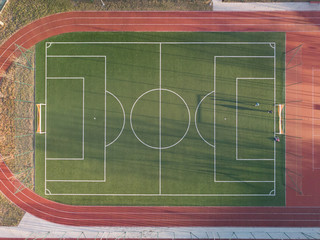 Shot from above on a green football field with white lines. 