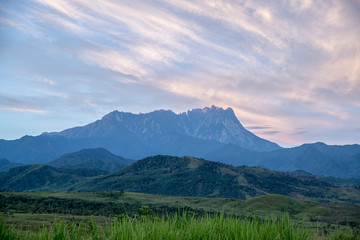 The majestic Mount Kinabalu peak highlighted when dawn's breaking. A view from Lasau Podi plains in Kota Belud.