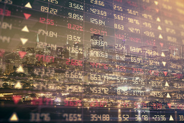 Financial graph on night city scape with tall buildings background double exposure. Analysis concept.