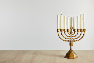 burning candles in menorah on Hanukkah isolated on white - obrazy, fototapety, plakaty
