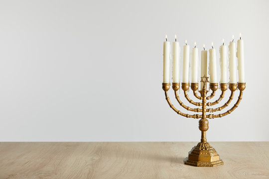 burning candles in menorah on Hanukkah isolated on white