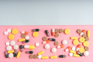 Medicine multicolor pills on colorful background closeup with space for text