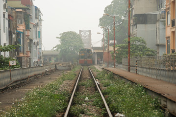 Naklejka premium A train going from Train Street on Long Bien Bridge in Hanoi, Vietnam 