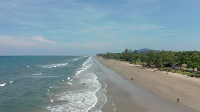 4K Aerial footage view of ocean waves crashing on Beautiful beach by at Sabandar Beach, Tuaran, Sabah, Malaysia