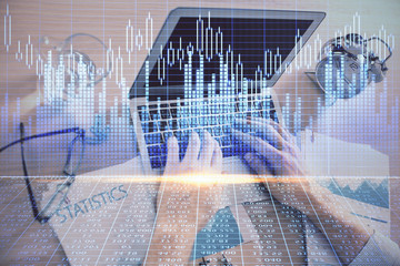 Multi exposure of forex graph with man working on computer on background. Concept of market analysis.