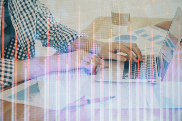 Multi exposure of stock market chart with man working on computer on background. Concept of financial analysis.