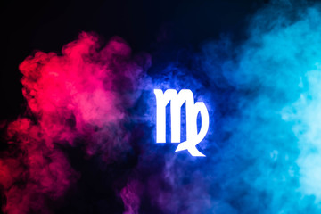 blue illuminated Virgo zodiac sign with colorful smoke on background