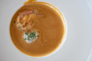 Shrimp cream soup with shrimps, parsley in plate