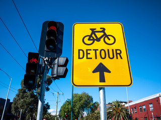 Sign of cycleway detour near traffic light on urban street. Melbourne, VIC Australia.