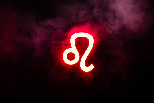 red illuminated Leo zodiac sign with smoke on background