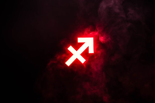 Red Illuminated Sagittarius Zodiac Sign With Smoke On Background