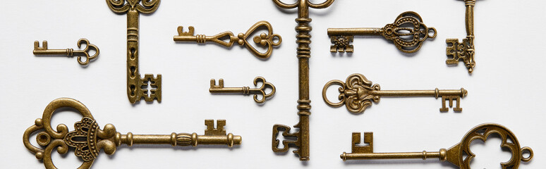 top view of vintage keys on white background, panoramic shot