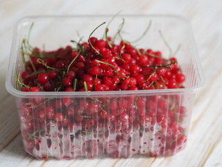 frozen chgoda red currants on a wooden white table