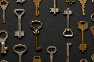 top view of vintage rusty keys on violet background
