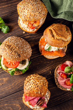 Overhead shoot with assorted sandwiches on wooden background. Healthy food concept. Top view.