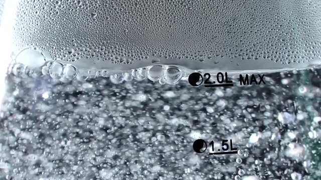 Water boils in a kettle. The process of boiling water. Bubbles with air in hot water.