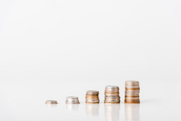 stacks of silver and golden coins on white