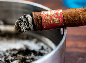 Burning cigar on an ashtray