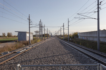 Looking down two sets of train tracks with overhead wires