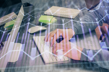 Stock graph with businessman typing on computer in office on background. Concept of analysis....