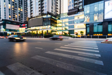 Hanoi cityscape at twilight with blurred asphalt road and modern buildings on background
