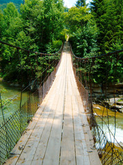 wooden bridge over the river in the forest