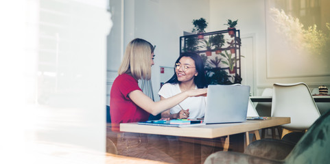 Obraz premium Content woman using laptop for freelance work with partner