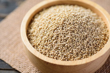 Raw brown quinoa seed in a bowl, close up