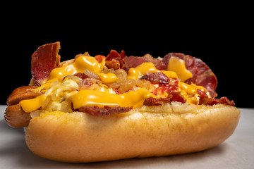 yummy hotdog with cheddar cheese and fried bacon