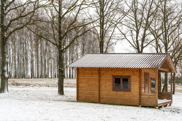 Small wooden house covered with snow