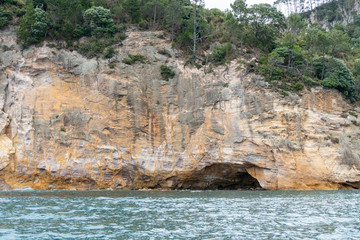 View of sea caves from Te Whanganui-A-Hei Cathedral Cove Marine Reserve in Coromandel Peninsula, New Zealand