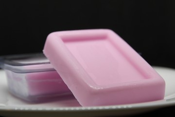 Homemade pink soap on black  background