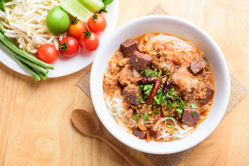 Northern Thai food (Kanom Jeen Nam Ngeaw), rice noodles with spicy soup eating with vegetables, top view