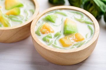 Thai dessert (Lod Chong), rice flour pandan flavor and sliced melon fruit in coconut milk