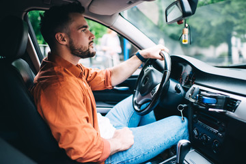 Concentrated male driving modern car