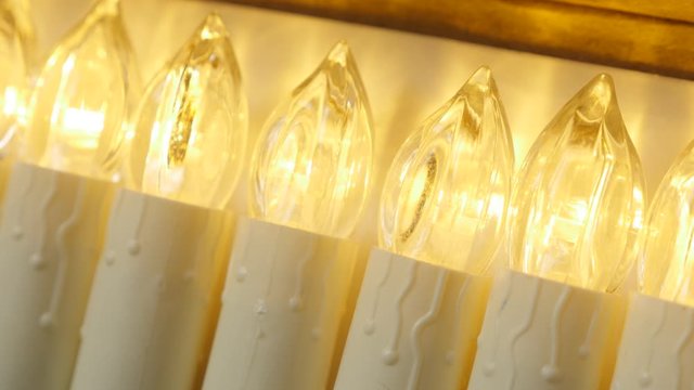 Row of white LED candles in a box 4K footage