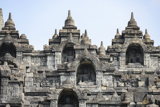 (Selective focus) Stunning view of the Borobudur Temple decorated with beautiful relief panels and Buddha statues. Borobudur is a Mahayana Buddhist temple in Central Java, Indonesia.