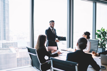 Businessman speaking to workers on meeting