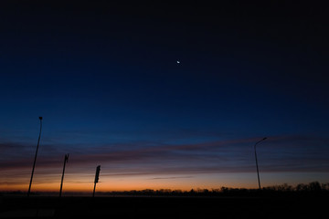 Naklejka premium Dawn on an empty road at five o'clock in the morning